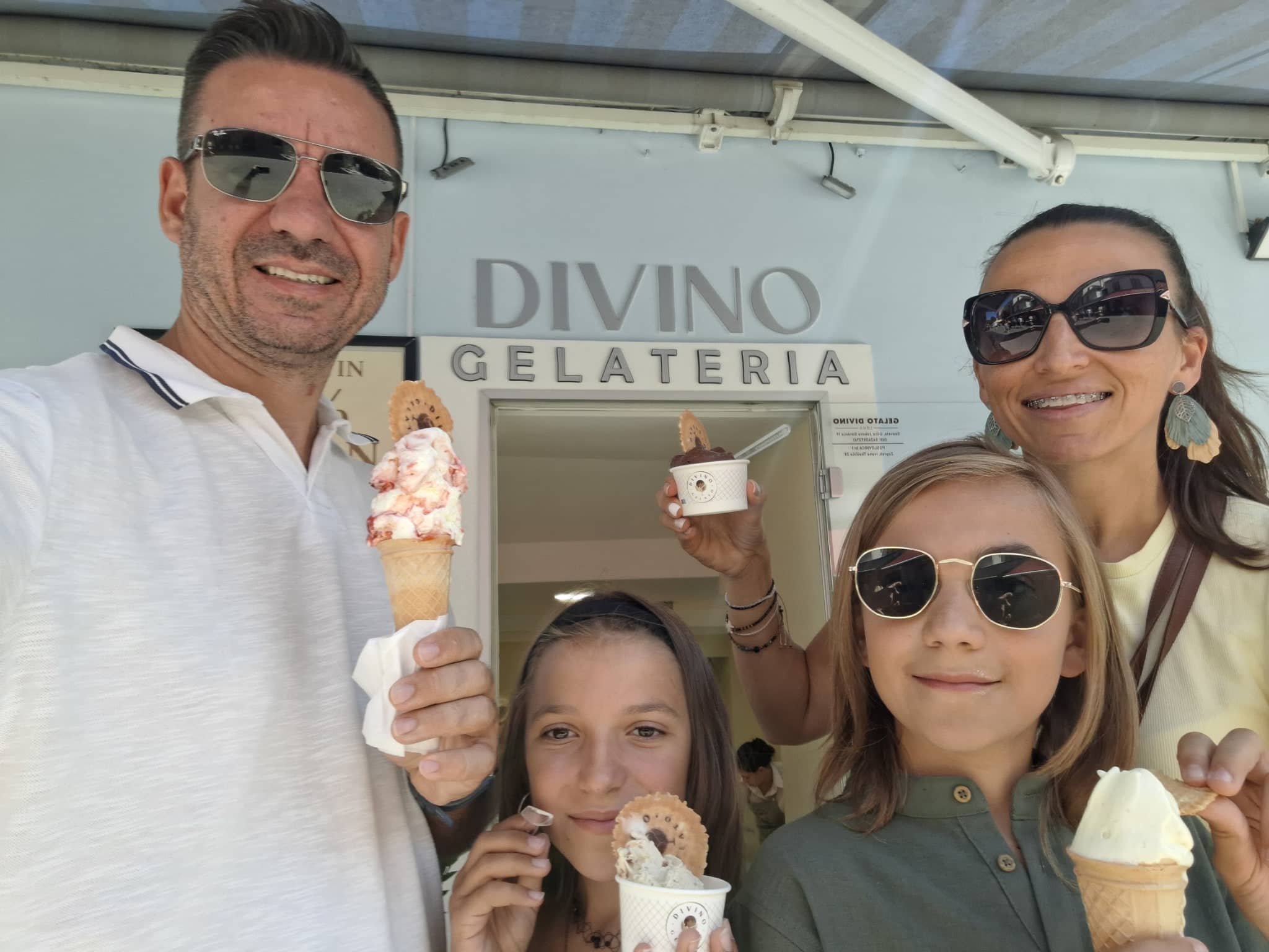 Stan with his family, all holding ice creams, in front of the Divino gelateria.
